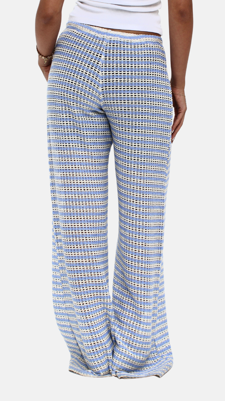 Blue checkered pants worn by a person on a white background
