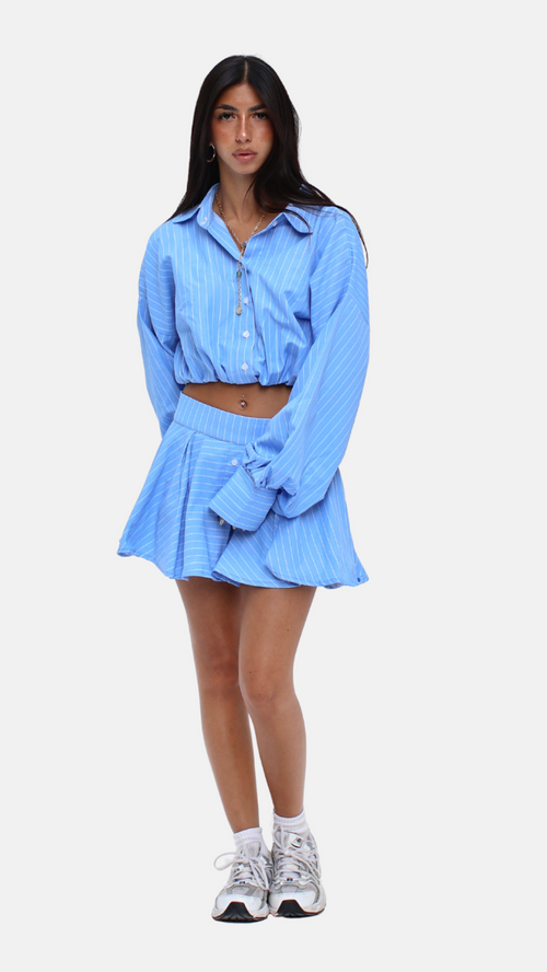 Woman wearing a blue checkered outfit on a white background