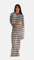 Woman wearing a patterned outfit on a white background