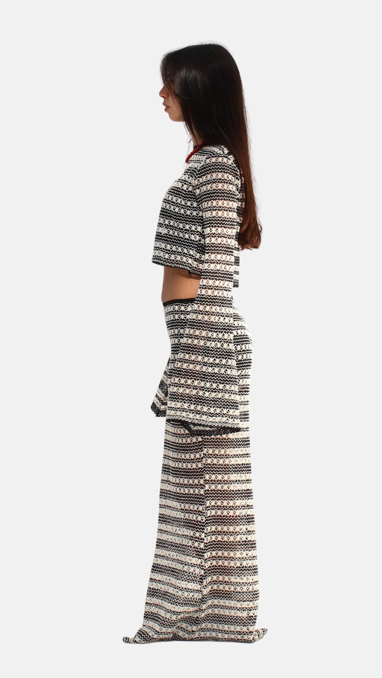 Woman wearing a patterned outfit on a white background