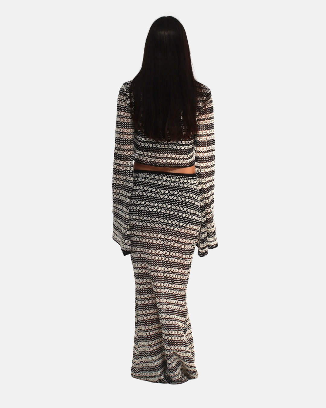 Person wearing a patterned dress on a white background