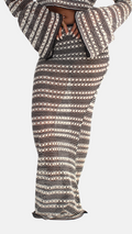 Person wearing a patterned outfit with a hood on a white background