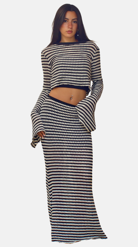 Woman wearing a black and white striped outfit on a white background