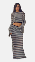 Woman wearing a black and white striped outfit on a white background