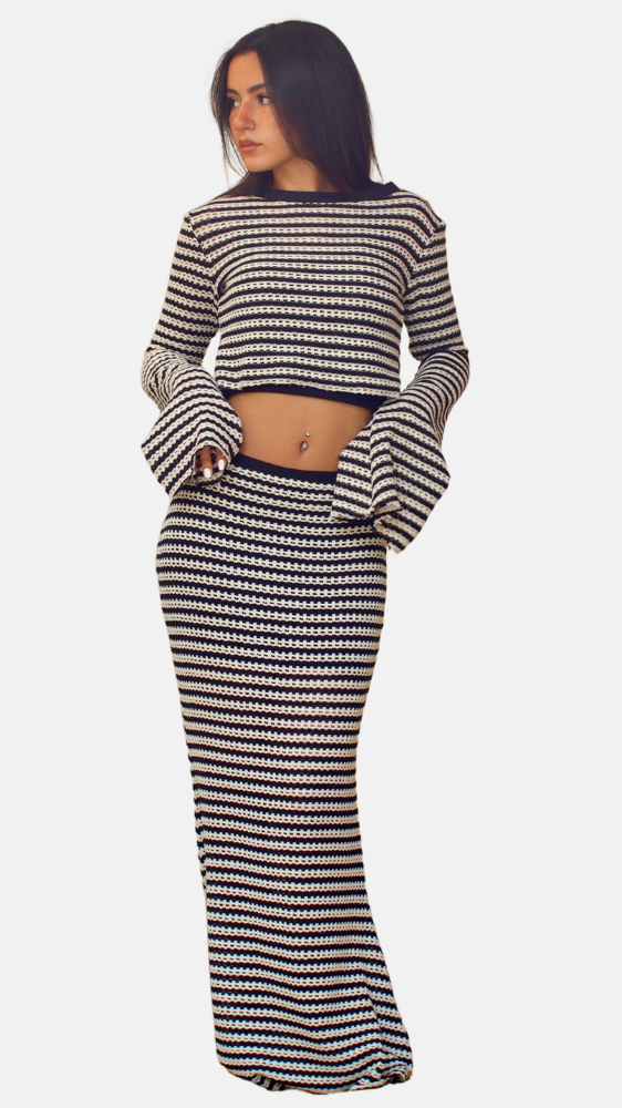 Woman wearing a black and white striped outfit on a white background