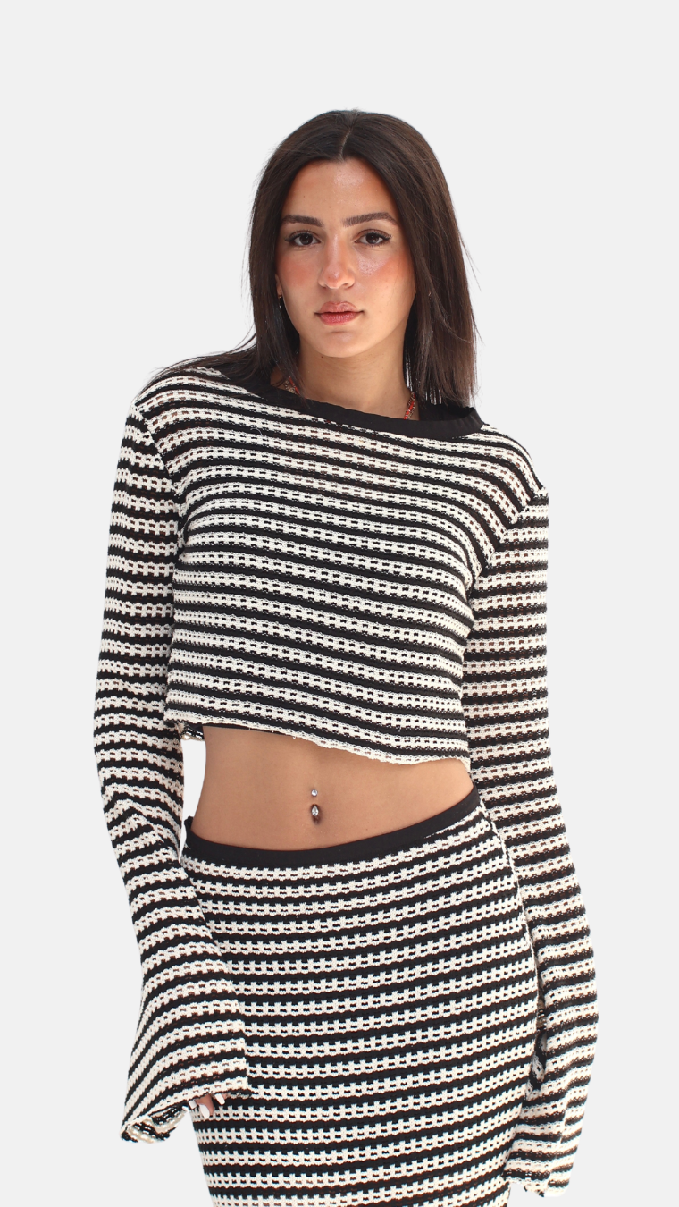 Woman wearing a black and white striped outfit on a white background