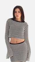 Woman wearing a black and white striped outfit on a white background